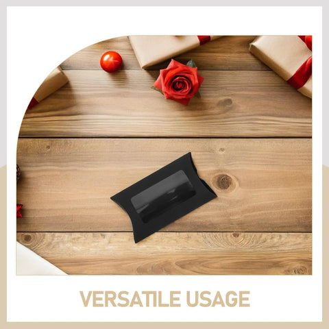 50 Pack Black Kraft Paper Pillow Gift Boxes With Window For Birthday Parties And Events on wooden table with decor