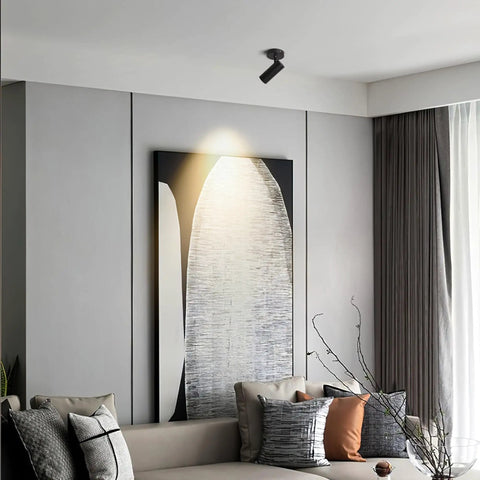 Image of a modern living room with LED Dimmable Ceiling Spotlight For Indoor Accent Lighting illuminating artwork.