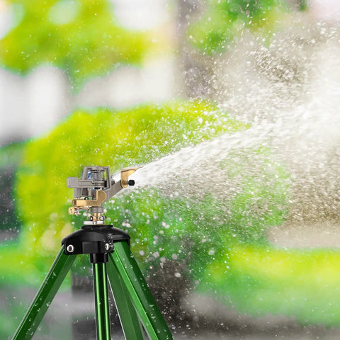 Two Pack 360 Degree Rotary Lawn Sprinklers On Metal Tripod Bases With Adjustable Height spraying water on lawn