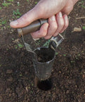 Hand using No Bend Bulb Planter With Depth Marker And Auto Release For Quick, Consistent Planting Of Tulips, Daffodils, Dahlias And Lilies In Heavier Soils For Home Gardens