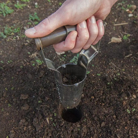 Hand using No Bend Bulb Planter With Depth Marker And Auto Release For Quick, Consistent Planting Of Tulips, Daffodils, Dahlias And Lilies In Heavier Soils For Home Gardens