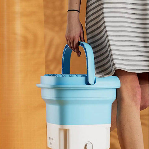 Person carrying Compact Portable Mini Washing Machine Foldable Washer With Spin Dryer Bucket for travel and home use
