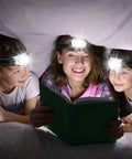 Family reading under a blanket using Five Pack LED Headlamps With 8 LEDs Four Lighting Modes Pivoting Head Adjustable Strap