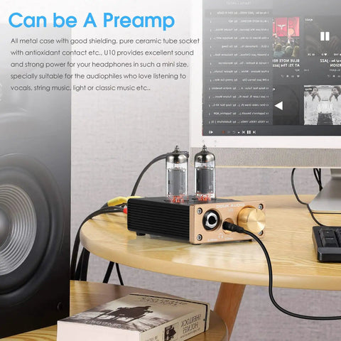 Dope U10 Mini Tube Headphone Amplifier with Dual Jacks on wooden table connected to computer screen