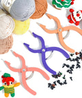 Foolproof Safety Eyes Jig Pliers For Doll Faces in purple and pink, surrounded by yarn balls and doll eyes for crafts.
