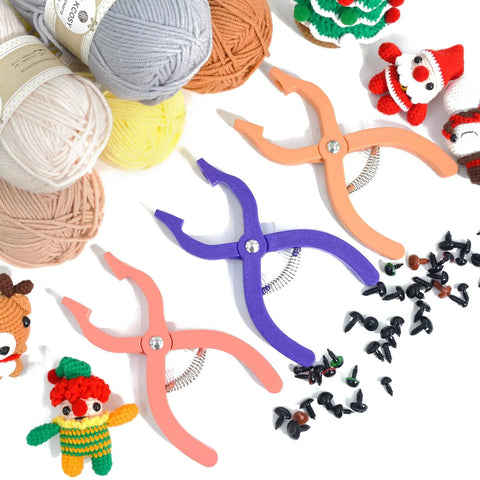 Foolproof Safety Eyes Jig Pliers For Doll Faces in purple and pink, surrounded by yarn balls and doll eyes for crafts.