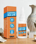 Fast Drying Ceramic Glue Adhesive For Porcelain And Tile Repairs, bottle and box, surrounded by broken porcelain pieces