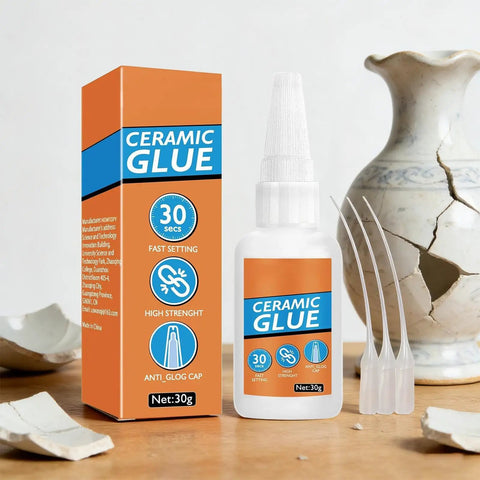 Fast Drying Ceramic Glue Adhesive For Porcelain And Tile Repairs, bottle and box, surrounded by broken porcelain pieces
