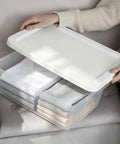 Heavy Duty Clear Plastic Storage Bins With Secure Snap On Lids Super Solid Twelve Quart Capacity Sweet Four Pack with folded clothes