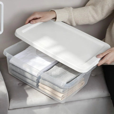 Heavy Duty Clear Plastic Storage Bins With Secure Snap On Lids Super Solid Twelve Quart Capacity Sweet Four Pack with folded clothes