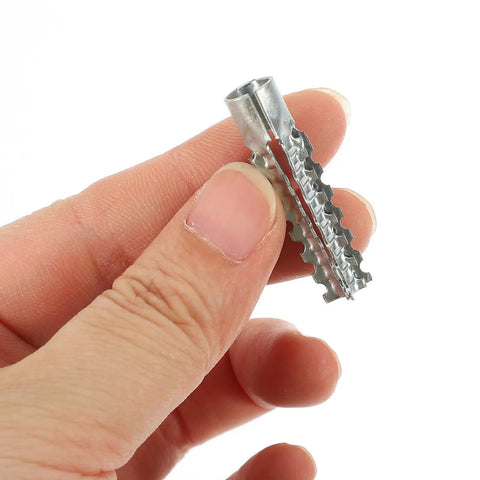 Close-up of a hand holding a serrated metal drywall anchor from the Heavy Duty Steel Hollow Wall Anchors With Screws Kit for Drywall and Plaster Walls.