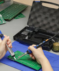 Hands using 65W Digital Soldering Iron Kit With Precise Temperature Control From 194 To 896 Fahrenheit And Celsius Display on circuit board