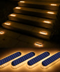 Solar step lights illuminating outdoor stairs with a warm glow at night, showcasing energy-efficient outdoor lighting solutions.