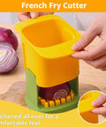 French fry cutter handheld vegetable chopper, yellow and green plastic body, hand-press, two onions visible.