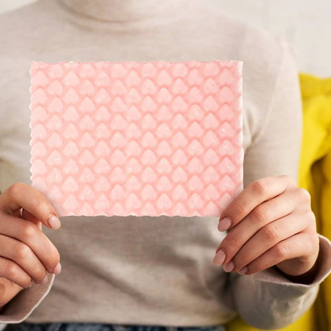 Person holding a Pink Heart Shaped Bubble Mailers Pack 50 Lightweight Shockproof Envelopes For Jewelry and Collectibles