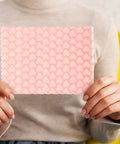 Person holding pink heart shaped bubble mailer for shipping lightweight plastic packaging bags for small biz packaging supplies