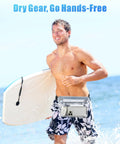 Man with surfboard wearing waterproof fanny pack pouch for beach and cruise trips with roll top closure and zippers, ocean in background.