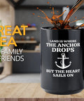 Fifteen Ounce Black Coffee Mug For Lake Lovers And Boat Captains With Land Is Where Theme Funny Boating Gift For Boaters Sailors Lake Life Fans And Outdoor Enthusiasts on a kitchen counter with coffee splash.