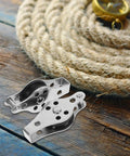 Stainless Steel Boat Pulley Wheel 2 Pack For Kayaks And Sailboats, resting on wooden surface next to coiled rope.