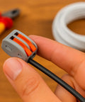 Hand holding 110 Piece Compact Lever Connector Kit With Push In Terminals 2 And 3 Port Splice Blocks For Electrical Wiring AWG Cable Joiners