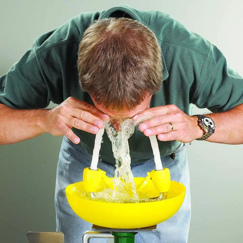 Person using Yellow Wall Mounted Emergency Eyewash Station With Dual Spray Heads And Hands Free Activation 15 Minute Flush