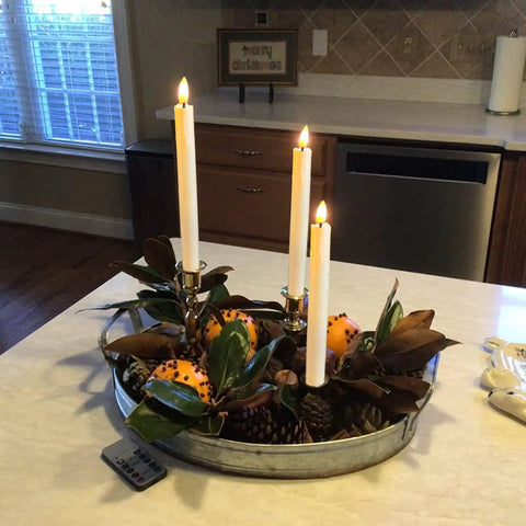 Battery Operated Flameless Taper Candles With Remote And Timer on a decorative tray in a kitchen setting