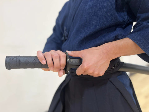 Person handling Polypropylene Short Katana Black Sword With Black Scabbard 23.5 Inch Overall Length 16 Inch Blade Martial Arts Practice
