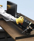Person using MB48B 48 Inch Pan Style Mini Brake for portable on-the-job pans, bending 22 gauge galvanized steel, on a workbench.