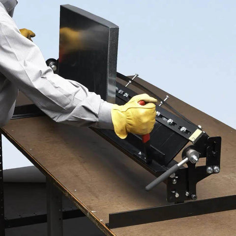Person using MB48B 48 Inch Pan Style Mini Brake for portable on-the-job pans, bending 22 gauge galvanized steel, on a workbench.