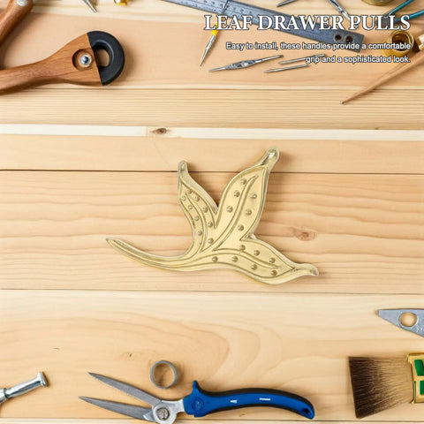 Brass Leaf Drawer Pulls For Cabinets And Wardrobes, Vintage Kitchen Cupboard Hardware; leaf-shaped brass pull on wood surface