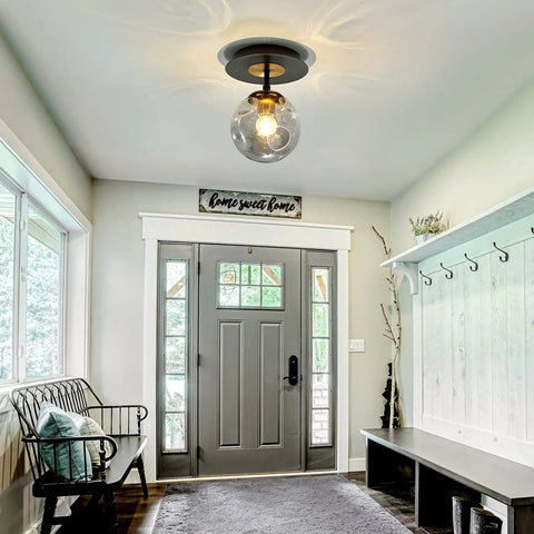 Sleek 1 Light Mini Glass Globe Ceiling Light in black finish, semi flush mount, installed in a bright hallway entry.