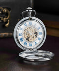 Mechanical Pocket Watch With Magnifier Case And Half Hunter Engraved Silver Chain Skeleton Dial Roman Numerals Classic Vintage Style For Men And Women Jewelry Quality Timepiece For Casual Or Business Wear, open showing skeleton dial and blue Roman numerals.