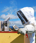 Beekeeping Essentials Starter Kit For Beginners With Full Body Bee Suit Including Bee Smoker and Hive Tool in use