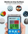 Close-up of Genuine Static Meter And Electrostatic Fieldmeter for Quick ESD Touch Ups measuring surfaces like rubber, paper, and textile.