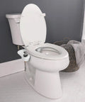 SlimEdge Non Electric Bidet Attachment For Toilet With Dual Front And Rear Nozzles Cold Water Wash installed on white toilet.