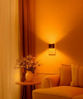 Cozy room with Two Pack Vintage LED Night Lights With 3000K Warm And 5000K Cool Dimmable Brightness, illuminating wall near sofa.