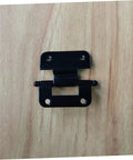 Front view of a black iron heavy-duty cabinet hinge with two mounting plates and screw holes on a wooden surface.