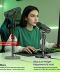 Ultra Low Desk Mic Stand With 5 Inch Adjustable Height All Metal Construction 6.6 Lbs Load Capacity Compact Tabletop Microphone Stand For Shure SM7B MV7 Yeti PodMic Rode PodMic MAONO For Pros And More, used by woman in home studio setup.