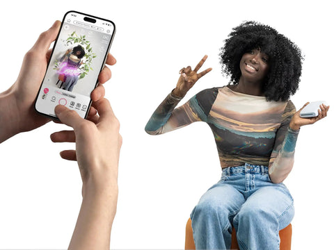 Person using iPhone to print a photo with Instax Mini Link 3 Smartphone Printer; woman sitting and holding phone.