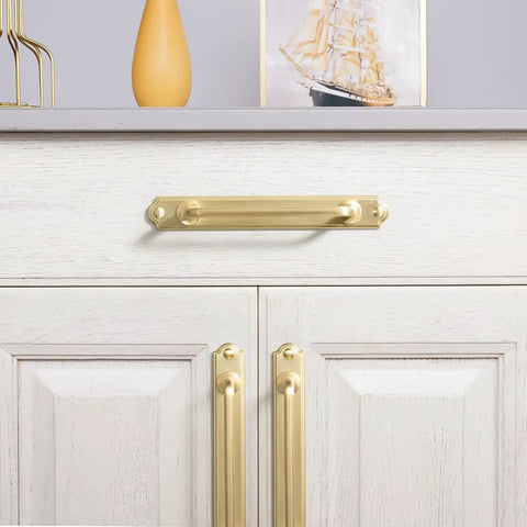 7.56 Inch Cabinet Handles In Brushed Brass installed on a white cabinet, showing sleek design with backplate and solid zinc alloy material.
