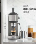 Compact Stainless Steel Espresso Maker With Built In Milk Frother Shoots Pro Level Lattes And Cappuccinos Daily Ultra Sleek Countertop Coffee Brewer Slays Your Cafe Routine Bang For The Buck standing on counter with espresso pouring.