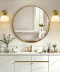 Feasey Vintage Milk Glass Globe Wall Sconce, Mid Century Ribbed Glass Light beside a round mirror in a modern bathroom.