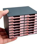 All-In-One 16-Drawer Diamond Art Tray Organizer Rack For Diamond Painting Supplies in hand view, solid black, pink drawers