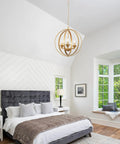 Gold Orb Chandelier Pendant Light Three Light Globe Fixture Modern Luxury Dining Room Foyer Kitchen Bedroom With Adjustable Height Openwork Metal Spheres For A Luxe Glam Vibe in bedroom setting.