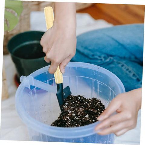 Person using wooden garden tool handles pack of five for weeding and mowing multipurpose replacement grips in soil bucket.