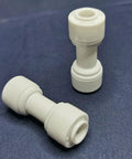 Water Purifier Straight Union Connector One Quarter Inch OD Tube Quick Push To Connect Fitting Made For Residential RO DI Water Filter Systems Durable Plastic Plumbing Connector Pack Of 100, two connectors on a dark background.