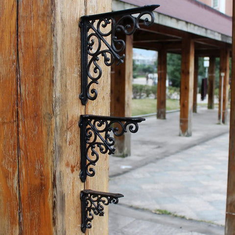 Built Tough Heavy Duty Cast Iron Wall Shelf Brackets Rust Proof 90 Degree Corner Braces on wooden post, showcasing elegant black metal design.
