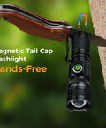 Rechargeable Mini Magnet Flashlight 1200 Lumen Zoomable EDC Light attached magnetically to a tree, demonstrating hands-free use.