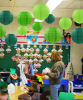 Classroom decorated with 12 Pack Green Party Paper Lanterns Set with 4 size variations in green tones, 6 8 10 12 inch, St. Patrick Day decor.