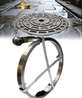 Smooth Operator Manual Crank Drain Snake Auger For Main Pipes And Outdoor Blockages Featuring Tough Corrosion Resistant Manganese Steel Tape on pavement next to a sewer cover.